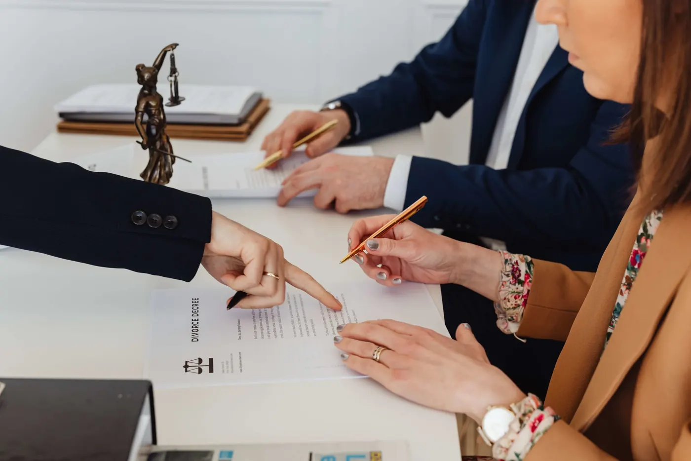 Attorneys reviewing a divorce decree at a desk
